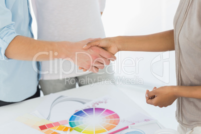 Interior designer shaking hands with customer