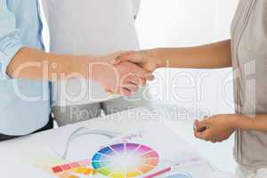 Interior designer shaking hands with customer
