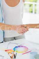 Interior designer shaking the hand of customer