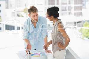 Interior designers looking at colour wheel and talking