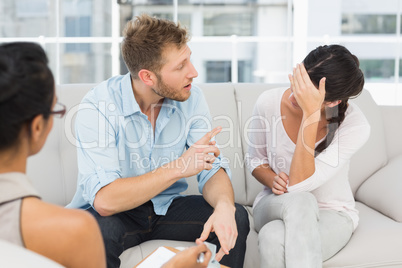 Unhappy couple fighting at therapy session