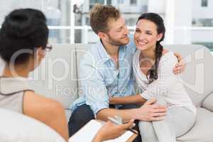 Happy couple reconciling at therapy session