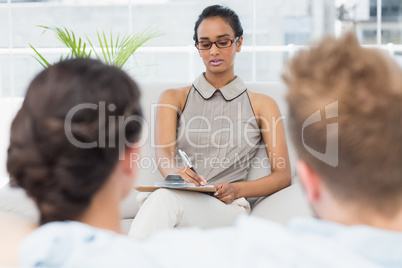 Therapist talking with couple on the couch