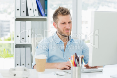 Handsome man working at his desk