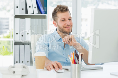 Smiling man working at his desk