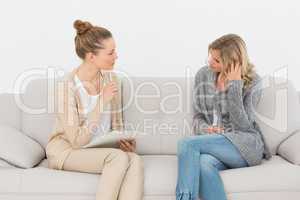 Upset woman talking to her therapist on the couch