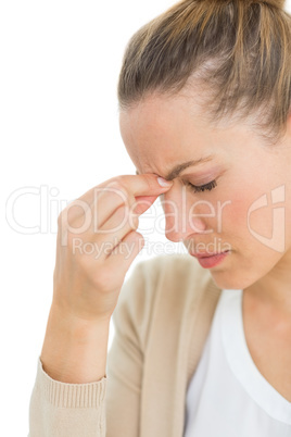 Woman with headache pinching her nose and wincing