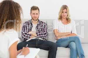 Unhappy couple not talking on the couch