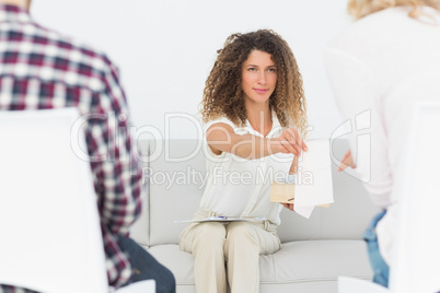 Therapist handing a tissue to woman at couples therapy