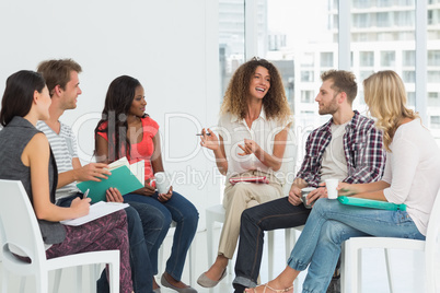 Smiling therapist speaking to a rehab group