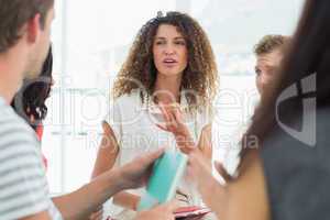 Smiling therapist talking with a rehab group