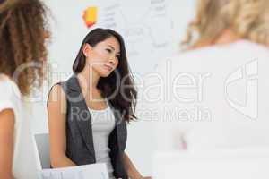 Asian woman listening at a meeting