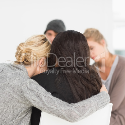 Women hugging in rehab group