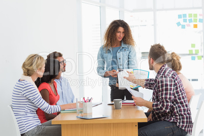 Woman presenting ideas to young designers having a meeting