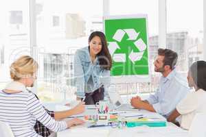 Smiling team having a meeting about recycling policy