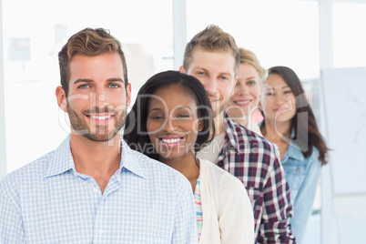 Design team standing in a line smiling at camera