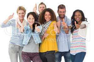 Happy group of young friends giving thumbs up to camera