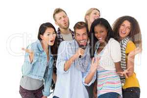 Happy group of friends having fun doing karaoke