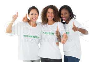 Happy team of volunteers giving thumbs up at camera