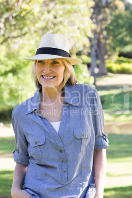 Happy woman wearing sunhat in park