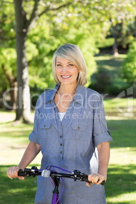 Woman with bicycle in park