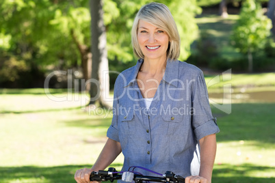 Woman with bicycle in park
