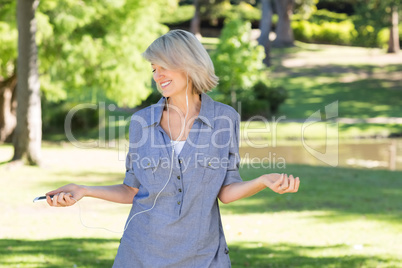 Woman listening music in park