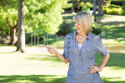 Woman enjoying music in park