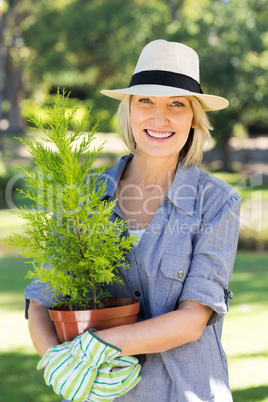 Woman holding potted plant for gardening