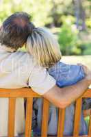 Couple relaxing on bench in park