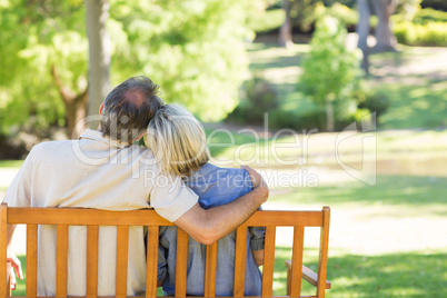 Couple relaxing on park bench