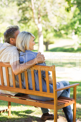 Couple relaxing on park bench