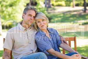 Loving couple relaxing on park bench