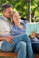 Affectionate couple reading book