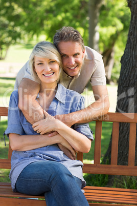 Loving man embracing woman in park