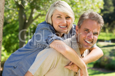 Man giving woman a piggyback ride