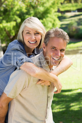 Man giving piggyback ride to woman