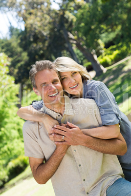 Couple with arm around in park