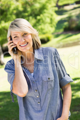 Woman using cell phone in park