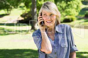 Woman talking on mobile phone in park