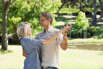 Couple dancing in countryside