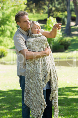 Man pointing something out to woman in park