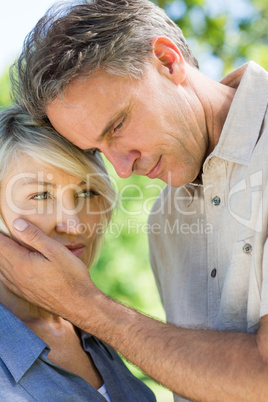 Man consoling woman in park