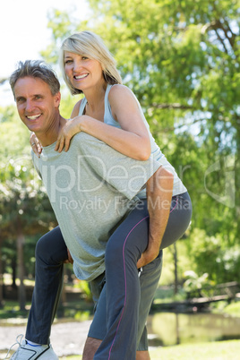 Man giving piggyback ride to woman