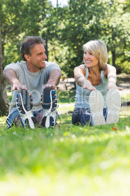 Couple stretching in the park