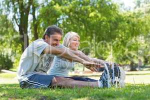 Couple stretching in the park