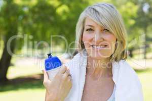 Woman holding water bottle in park