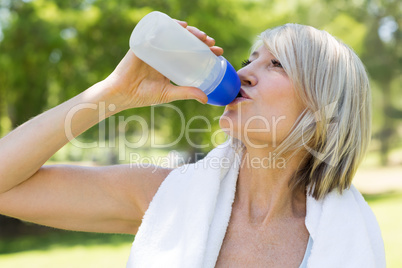 Woman drinking water in park