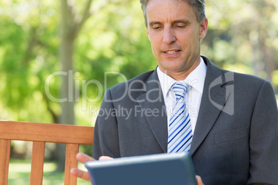 Mature businessman using digital tablet