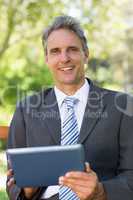 Portrait of businessman using digital tablet